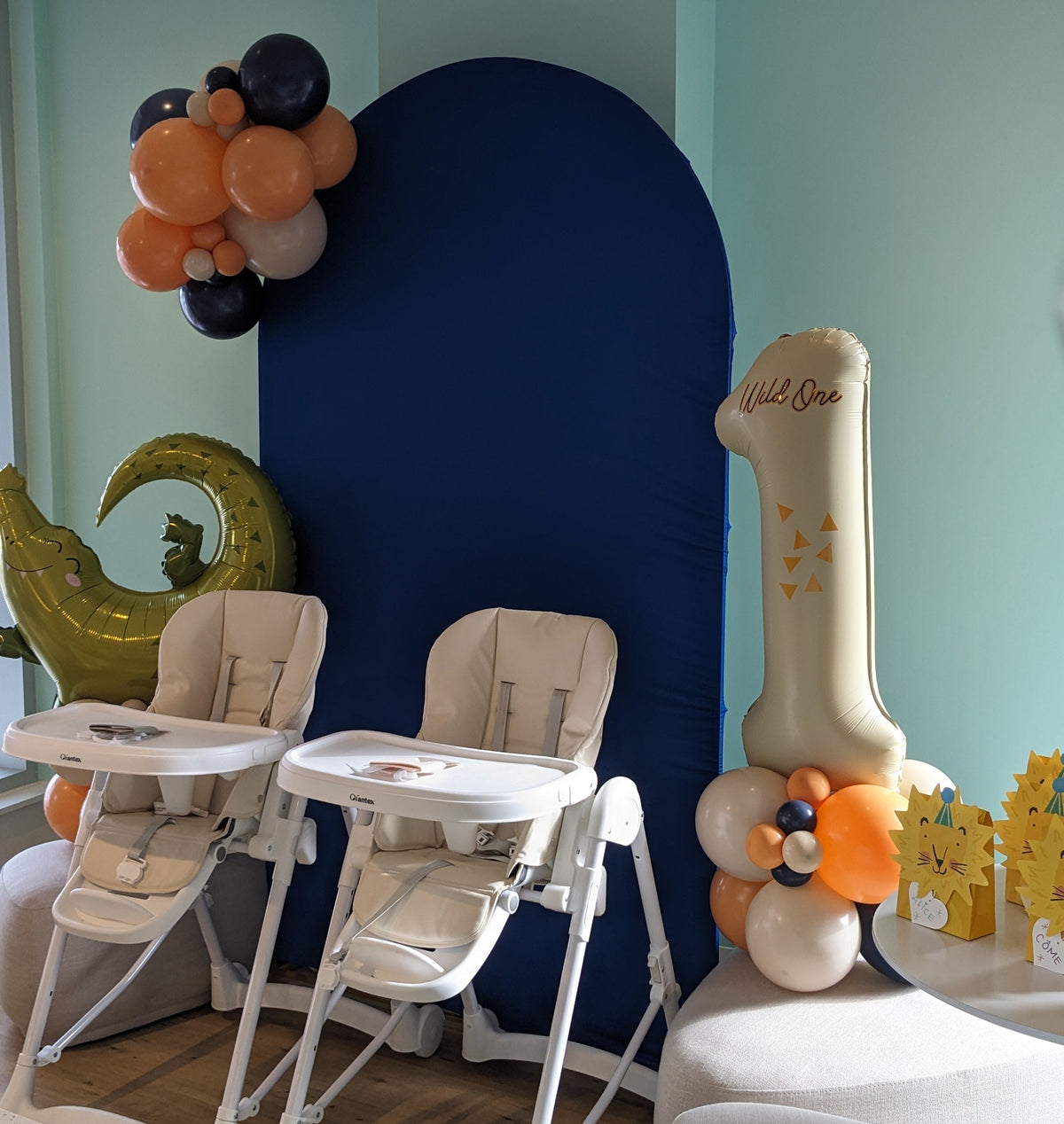Decorated space for toddler's first birthday party with lots of natural light and comfortable high chairs.